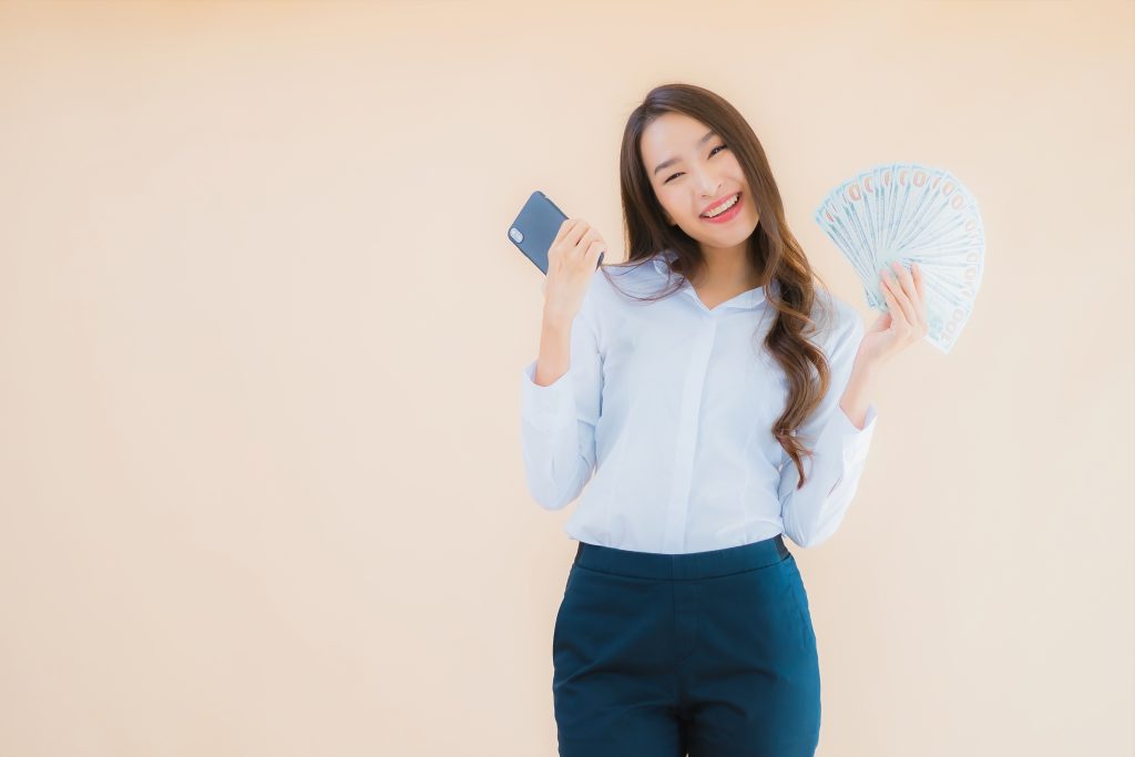 portrait beautiful young business asian woman with cash money